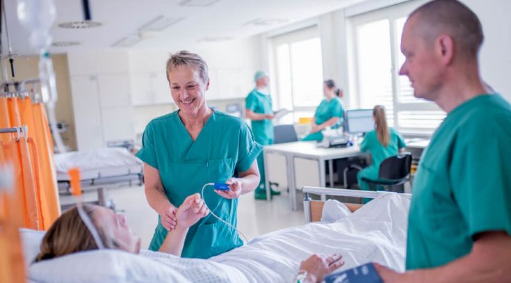 Pflegekräfte begleiten Patienten im Aufwachraum nach einer Operation
